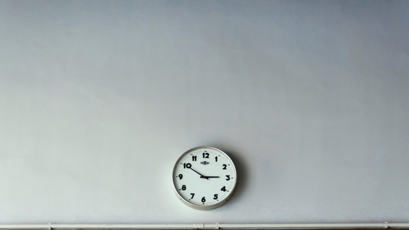 Analog clock on a pale grey wall